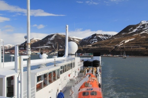 We say goodbye to Longyearbyen, a town we won't see for seven days as we say hello to our life aboard the ship. In the foreground you can see one of the bright orange lifeboats.