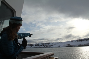 One of our naturalists, Elaine, points to polar bear tracks in the distance.